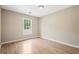 Comfortable bedroom bathed in natural light from the window, complementing the wood-look floors at 2382 Old Rex Morrow Rd, Ellenwood, GA 30294