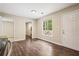 Open-concept dining space featuring hardwood floors, natural light, and a white door to the exterior at 2382 Old Rex Morrow Rd, Ellenwood, GA 30294