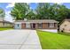 Charming brick home with a spacious front yard and long driveway at 2382 Old Rex Morrow Rd, Ellenwood, GA 30294