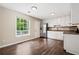 Kitchen featuring hardwood floors, white cabinets, and a stainless steel refrigerator at 2382 Old Rex Morrow Rd, Ellenwood, GA 30294