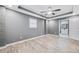 Large bedroom with grey walls, wood-look floors, and access to a bathroom at 1788 Rosewood Rd, Decatur, GA 30032