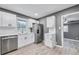 Renovated kitchen with white cabinets, stainless steel appliances, and grey walls at 1788 Rosewood Rd, Decatur, GA 30032