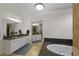 Large bathroom with double vanities, soaking tub, and walk-in shower at 610 Ashwood Ct, Woodstock, GA 30189