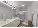 Clean bathroom with double vanity, shower/tub combo and updated fixtures at 610 Ashwood Ct, Woodstock, GA 30189