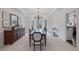 Elegant dining room features a large table, chandelier, and ample natural light at 610 Ashwood Ct, Woodstock, GA 30189