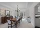 Bright dining room with a spacious table and access to the kitchen at 610 Ashwood Ct, Woodstock, GA 30189