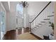 Spacious foyer with hardwood floors, high ceilings, and a grand staircase at 610 Ashwood Ct, Woodstock, GA 30189