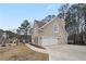 Two-car garage with a spacious driveway and a side patio at 610 Ashwood Ct, Woodstock, GA 30189