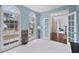 Home office with built-in shelves, an arched window, and a light blue wall at 610 Ashwood Ct, Woodstock, GA 30189