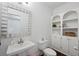 Powder room with pedestal sink and built-in shelving at 610 Ashwood Ct, Woodstock, GA 30189
