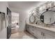 Elegant bathroom with double vanity, patterned wallpaper, and large mirror at 705 Glenforest Rd, Atlanta, GA 30328