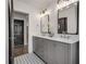 Bathroom with double vanity, marble countertop, and patterned floor at 705 Glenforest Rd, Atlanta, GA 30328