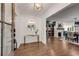 Bright entryway with hardwood floors, glass-top console table, and mirror at 705 Glenforest Rd, Atlanta, GA 30328