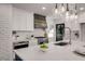 Renovated kitchen featuring white cabinets, marble countertops and herringbone backsplash at 705 Glenforest Rd, Atlanta, GA 30328