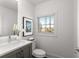 Clean and bright half bathroom with a white vanity and toilet at 1036 Culpepper Nw St, Atlanta, GA 30318