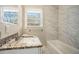 Updated bathroom with granite countertop, tile shower, and bathtub at 3860 Wisteria Sw Ln, Atlanta, GA 30331