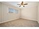 Bedroom with wood-paneled accent wall and neutral carpeting at 3860 Wisteria Sw Ln, Atlanta, GA 30331
