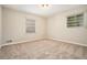 Spacious bedroom with neutral carpeting and multiple windows at 3860 Wisteria Sw Ln, Atlanta, GA 30331