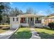 Updated ranch home with a covered porch, attached garage, and well-manicured lawn at 3860 Wisteria Sw Ln, Atlanta, GA 30331