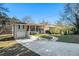 Ranch home with a long driveway, attached garage, and a landscaped yard at 3860 Wisteria Sw Ln, Atlanta, GA 30331