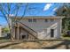 Rear view of house showcasing wooden stairs and backyard at 3860 Wisteria Sw Ln, Atlanta, GA 30331