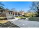 Front view of charming house with a red door and landscaped yard at 3860 Wisteria Sw Ln, Atlanta, GA 30331