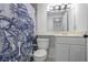 Clean bathroom featuring a nautical-themed shower curtain and a white vanity at 620 Peachtree Ne St # 1206, Atlanta, GA 30308