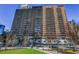 Striking exterior shot of a high rise building with a manicured green lawn and street view at 620 Peachtree Ne St # 1206, Atlanta, GA 30308