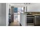 Open concept kitchen with stone countertops, stainless steel appliances, and hardwood floors at 620 Peachtree Ne St # 1206, Atlanta, GA 30308