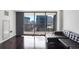 Comfortable living space with a large window offering a view of the city skyline at 620 Peachtree Ne St # 1206, Atlanta, GA 30308