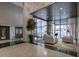 Open concept lobby with high ceilings, plants, and modern furniture at 620 Peachtree Ne St # 1206, Atlanta, GA 30308