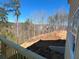 View from a new deck to the unfinished backyard, ready for your landscape design at 628 Gilles Ln, Cumming, GA 30041