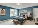 Charming bedroom featuring neutral carpet, a cozy bed and natural light through the windows at 628 Gilles Ln, Cumming, GA 30041