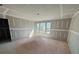 Spacious bedroom showing new construction with drywall installed and three windows overlooking the yard at 628 Gilles Ln, Cumming, GA 30041