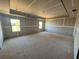 Spacious bedroom under construction with exposed concrete floors and two bright windows at 628 Gilles Ln, Cumming, GA 30041