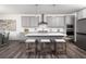 A modern kitchen with gray cabinets, stainless steel appliances, and a white quartz island at 628 Gilles Ln, Cumming, GA 30041