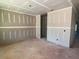 Unfinished living room area with visible outlets and view to other spaces in the home at 628 Gilles Ln, Cumming, GA 30041