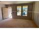 Unfinished living room with new front door and light, view to yard via two large windows at 628 Gilles Ln, Cumming, GA 30041