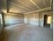 Bright living room under construction with exposed concrete floors and recessed lighting at 628 Gilles Ln, Cumming, GA 30041