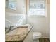 Bathroom with granite countertop and white tile at 2190 Greystone Way, Decatur, GA 30032