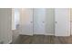 Hallway with wood-look flooring and access to bedrooms at 2190 Greystone Way, Decatur, GA 30032