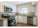 Modern kitchen featuring stainless steel appliances and granite countertops at 2190 Greystone Way, Decatur, GA 30032