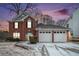 Brick house with 2-car garage, freshly landscaped yard, and snowy lawn at 4057 Crossings Way, Stone Mountain, GA 30083