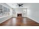 Living room featuring a brick fireplace and hardwood floors at 4057 Crossings Way, Stone Mountain, GA 30083