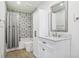 Modern bathroom with white vanity, patterned tile, and shower/tub combo at 4386 Bluebird Ln, Lithia Springs, GA 30122
