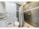 Modern bathroom with grey tile shower and white toilet at 4386 Bluebird Ln, Lithia Springs, GA 30122