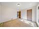 Well-lit bedroom featuring a window, carpet, and door at 4386 Bluebird Ln, Lithia Springs, GA 30122