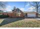 Brick ranch house with large window, attached garage, and fenced yard at 4386 Bluebird Ln, Lithia Springs, GA 30122