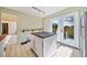 Kitchen features island, tile floor and access to backyard at 4386 Bluebird Ln, Lithia Springs, GA 30122