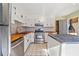 Modern kitchen with stainless steel appliances and tile flooring at 4386 Bluebird Ln, Lithia Springs, GA 30122